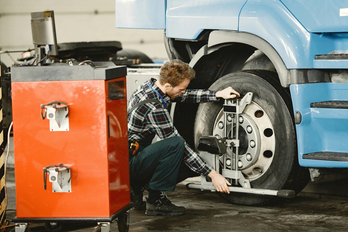 mechanic aligning the wheels of a truck